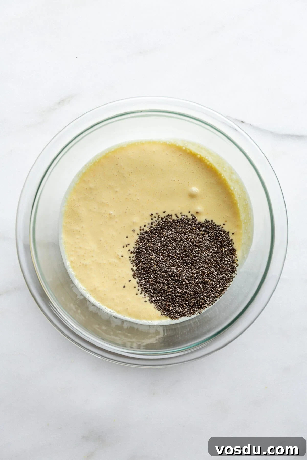 Creamy Lemon Chia Pudding Recipe for Bright Morning Meals 6 chia seeds and lemon cream in a clear mixing bowl.
