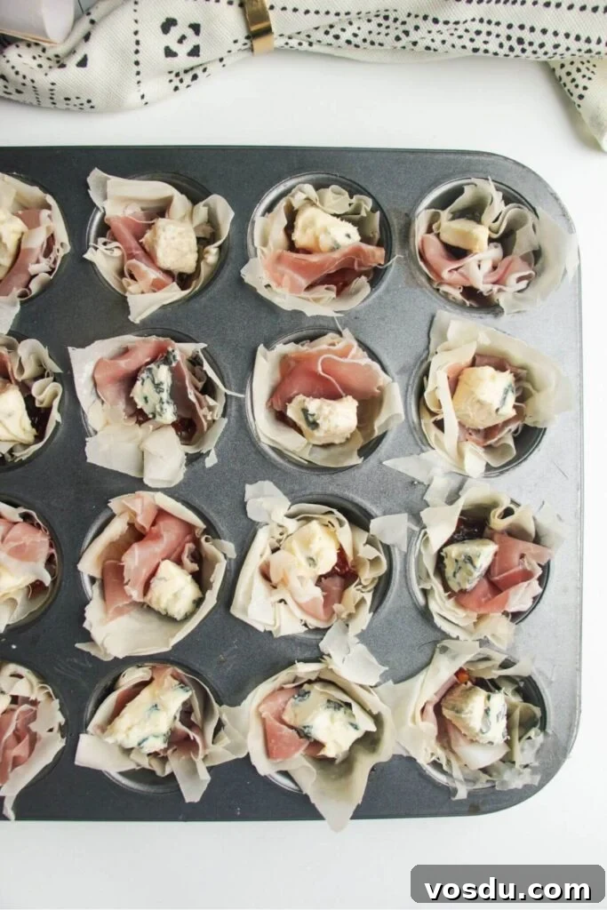 Blue Cheese, Prosciutto & Sweet Chili Filo Cups Recipe 6 Unbaked blue cheese filo cups in a mini muffin tin.