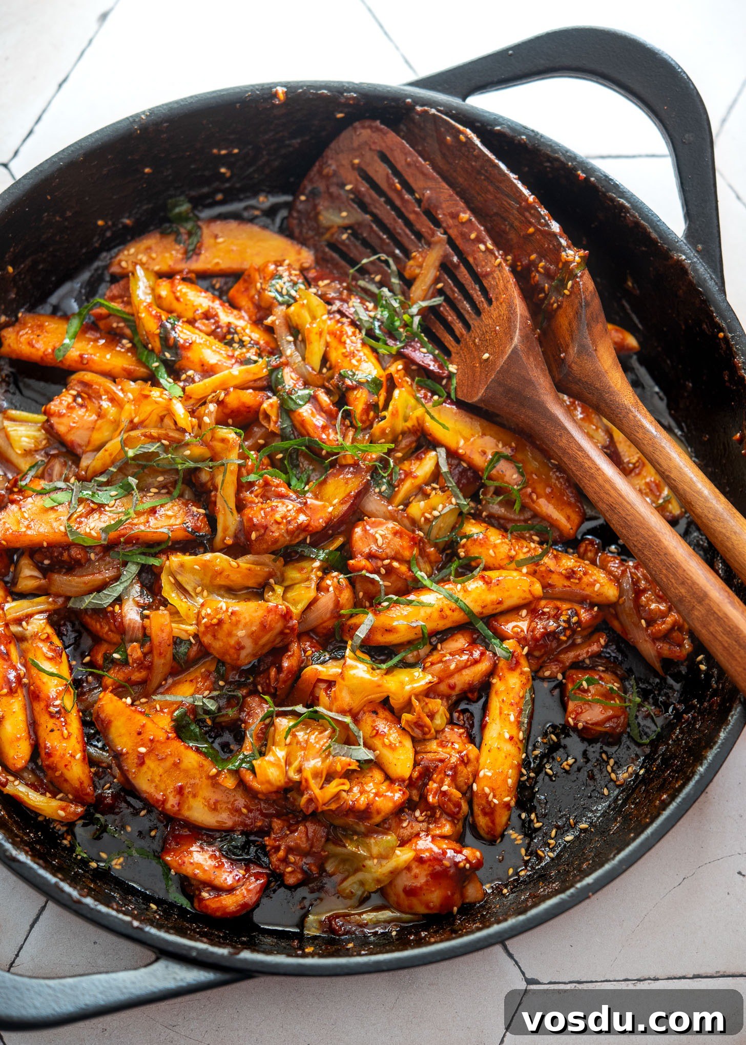 Dakgalbi Recipe: Spicy Korean Stir-Fried Chicken with Vegetables 2 Dakgalbi in a skillet with chicken, rice cakes, and vegetables