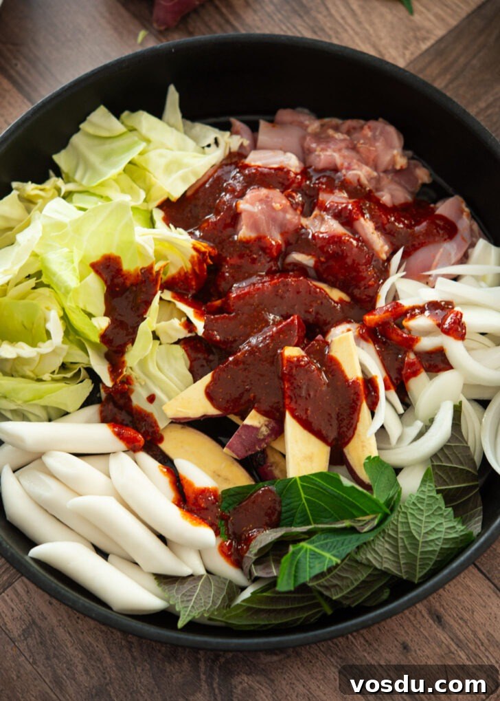 Dakgalbi Recipe: Spicy Korean Stir-Fried Chicken with Vegetables 6 Spicy dakgalbi sauce poured onto chicken and vegetables
