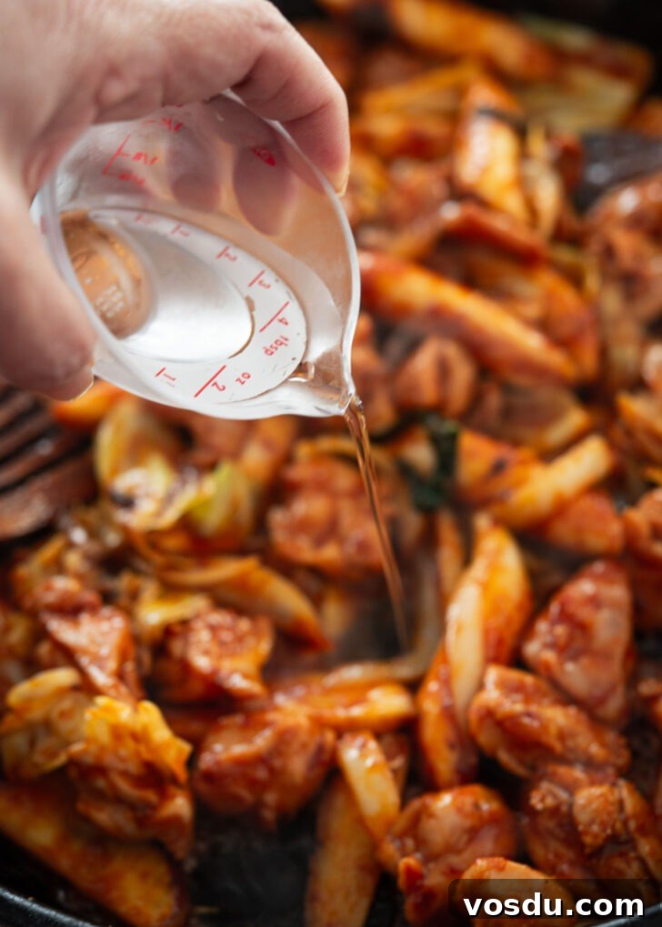 Dakgalbi Recipe: Spicy Korean Stir-Fried Chicken with Vegetables 7 Water added to stir-fried chicken and vegetables
