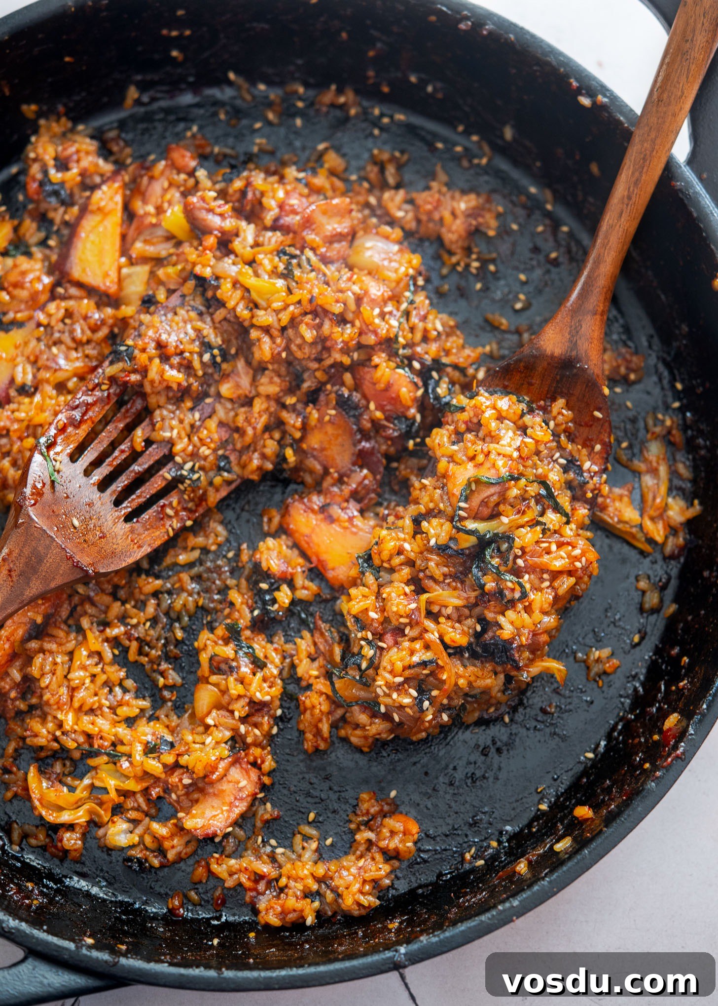 Dakgalbi Recipe: Spicy Korean Stir-Fried Chicken with Vegetables 9 Dakgalbi fried rice in a pan with spatulas