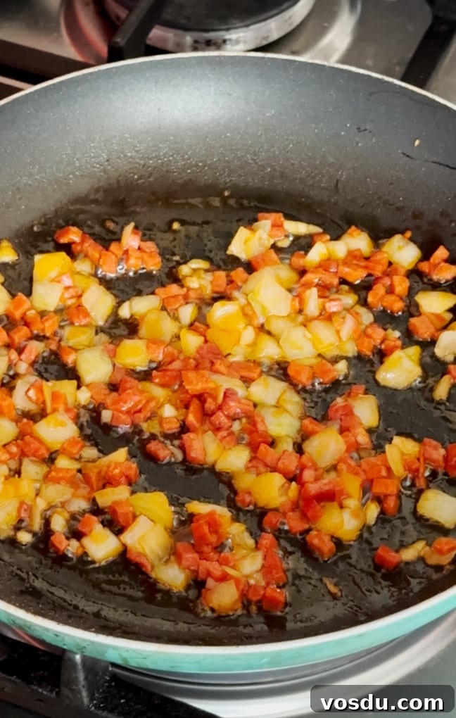 Quick 10-Minute Kids' Paella: Flavorful Family Meal 6 Ingredients added to a frying pan.