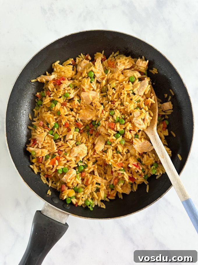 Quick 10-Minute Kids' Paella: Flavorful Family Meal 8 Cooked Paella in a frying pan ready to be served.