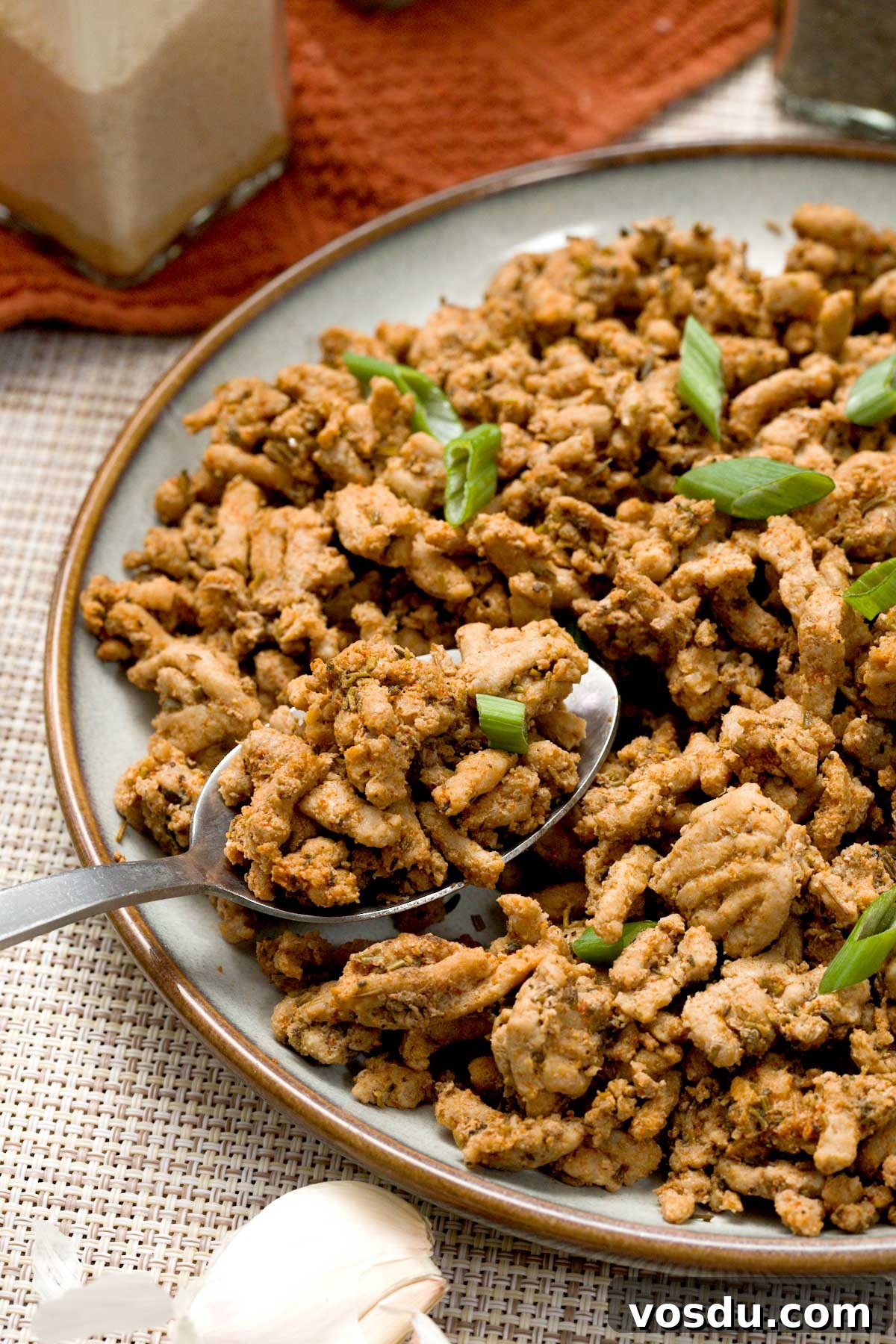 Maple Sage Ground Turkey Breakfast Sausage Recipe – Juicy & Flavorful 4 Close-up of breakfast ground turkey sausage with maple, sage and rosemary on a plate with a spoon.