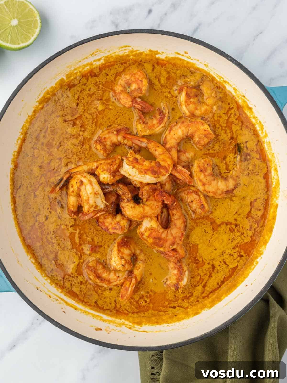 Thai Coconut Shrimp Curry Recipe — Creamy Coconut Prawn Curry 6 Adding shrimp to the curry sauce.