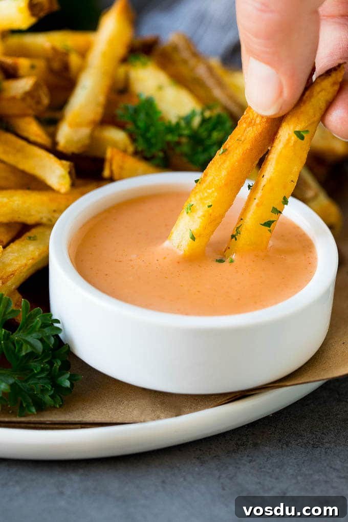 Fry Sauce Recipe #sauce #dinneratthezoo A hand dipping french fries into fry sauce.