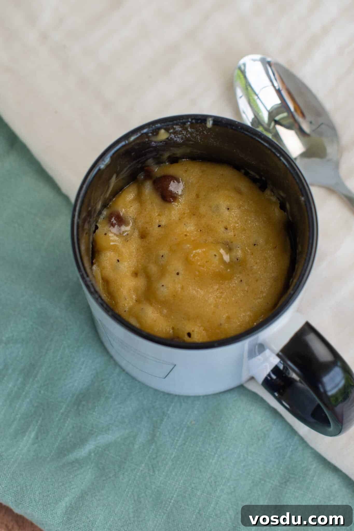 Sourdough Mug Cookie Recipe: Quick Single-Serve Treat 7 A cooked cookie in a mug with visible chocolate chips.