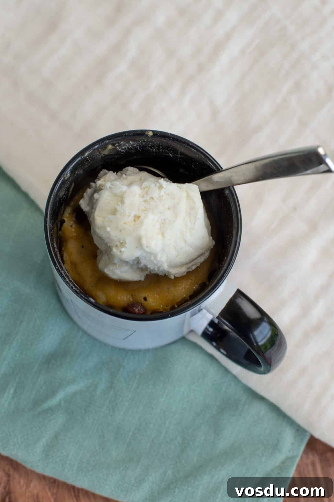 Sourdough Mug Cookie Recipe: Quick Single-Serve Treat 8 Ice cream tops the cookie in a mug.