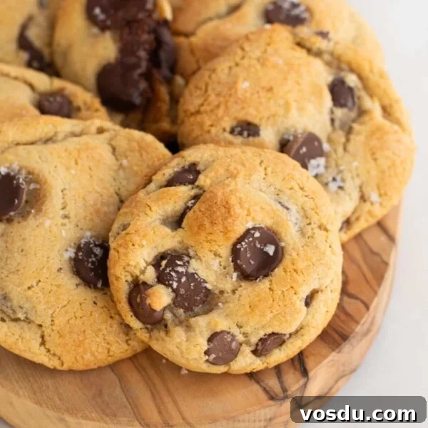 A wooden board filled with sourdough chocolate chip cookies.