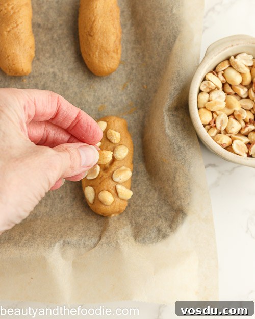 Keto Payday Candy Bar Recipe: Low-Carb Payday-Style Treat 17 Adding the peanuts to the bars.