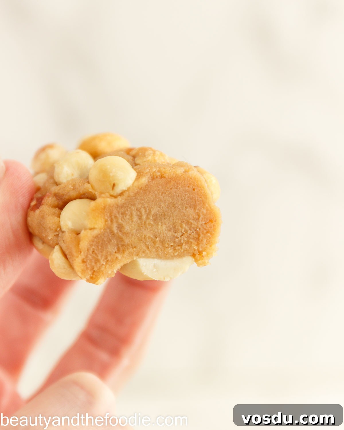 Keto Payday Candy Bar Recipe: Low-Carb Payday-Style Treat 5 A keto payday bar held in a hand with a bit out of it.