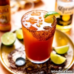 Michelada served with lime wedges.