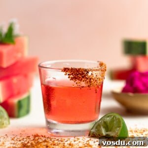 Shot glass filled with Mexican Candy shot. Slices of watermelon on the side.