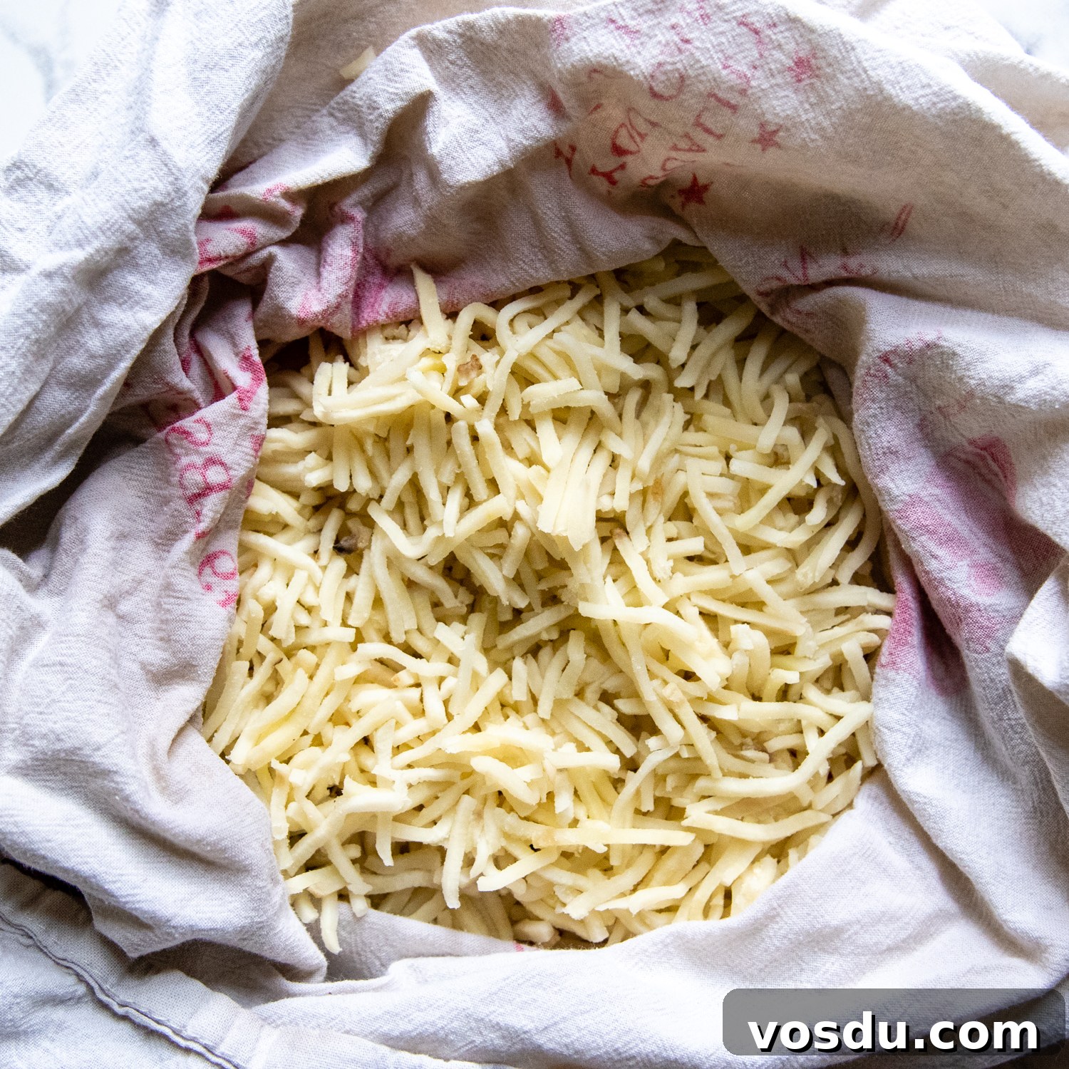 thawed hashbrowns in a lint free dish towel.