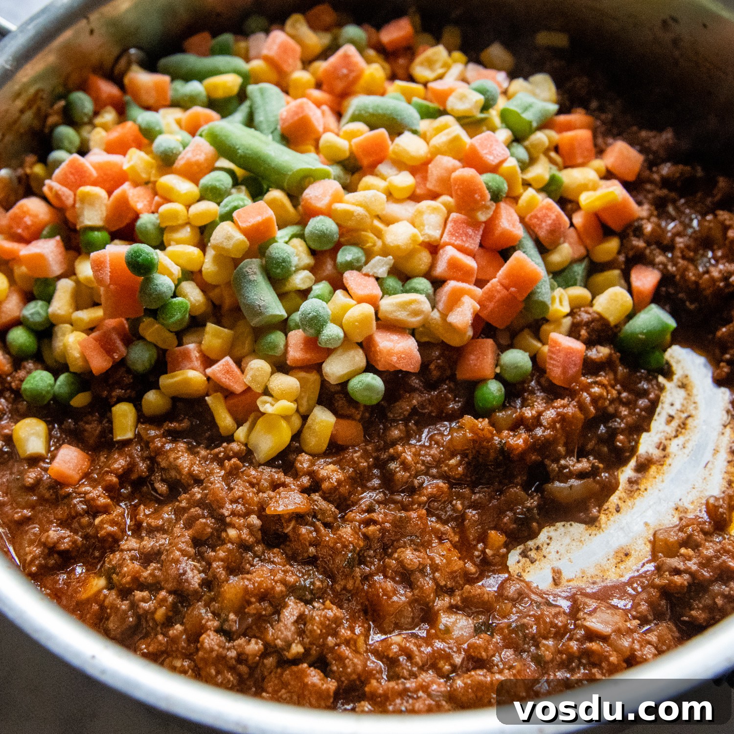 frozen mixed veggies being added the beef.