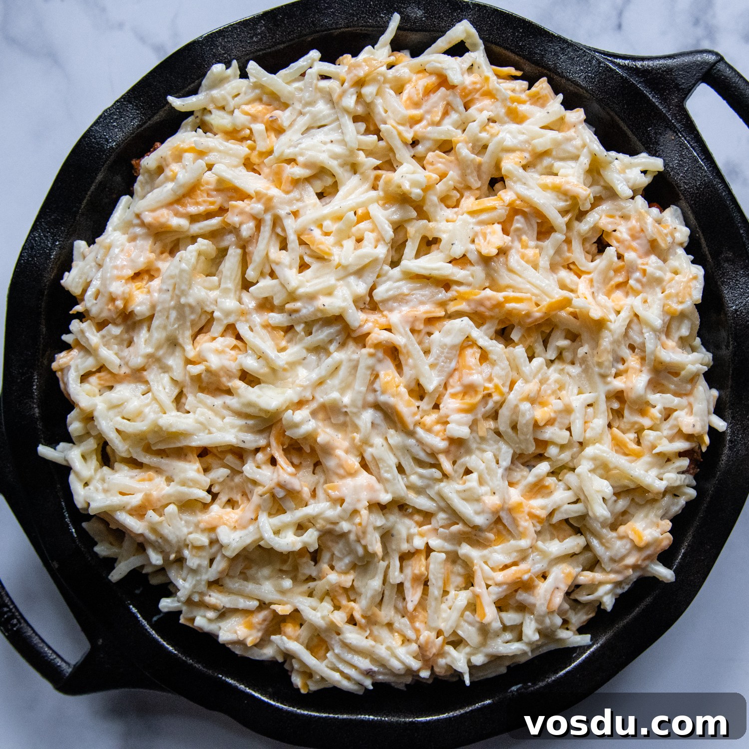 cheesy hash brown topping over the casserole before baking.
