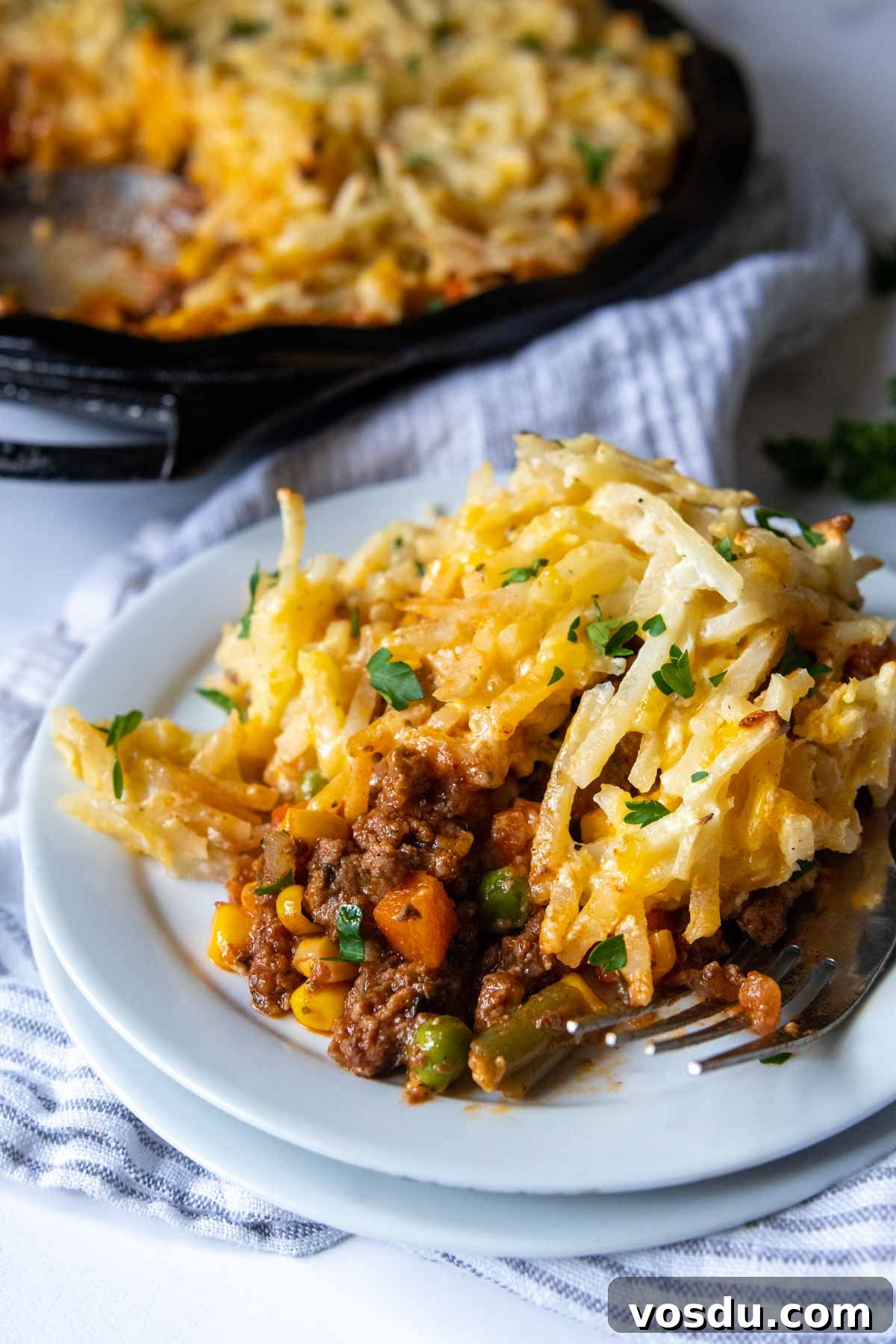 a serving of cottage pie on a white plate.
