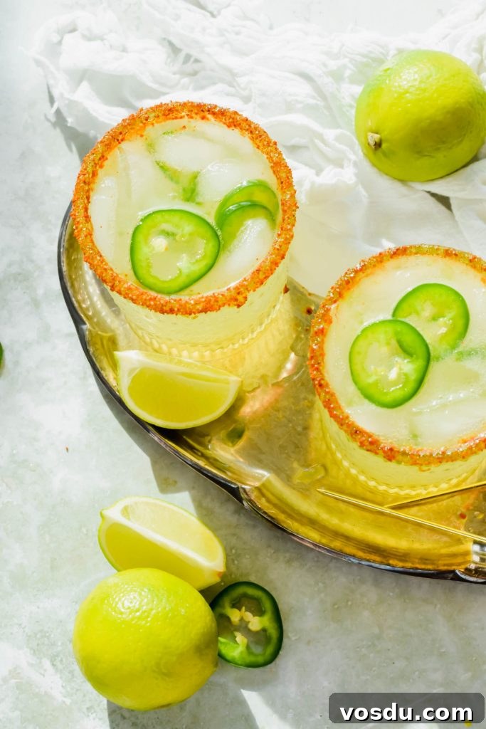 Readers' Top 10 Favorite Recipes of 2022 3 Overhead shot of two Spicy Skinny Jalapeno Margaritas on a gold serving tray next to toothpicks and limes