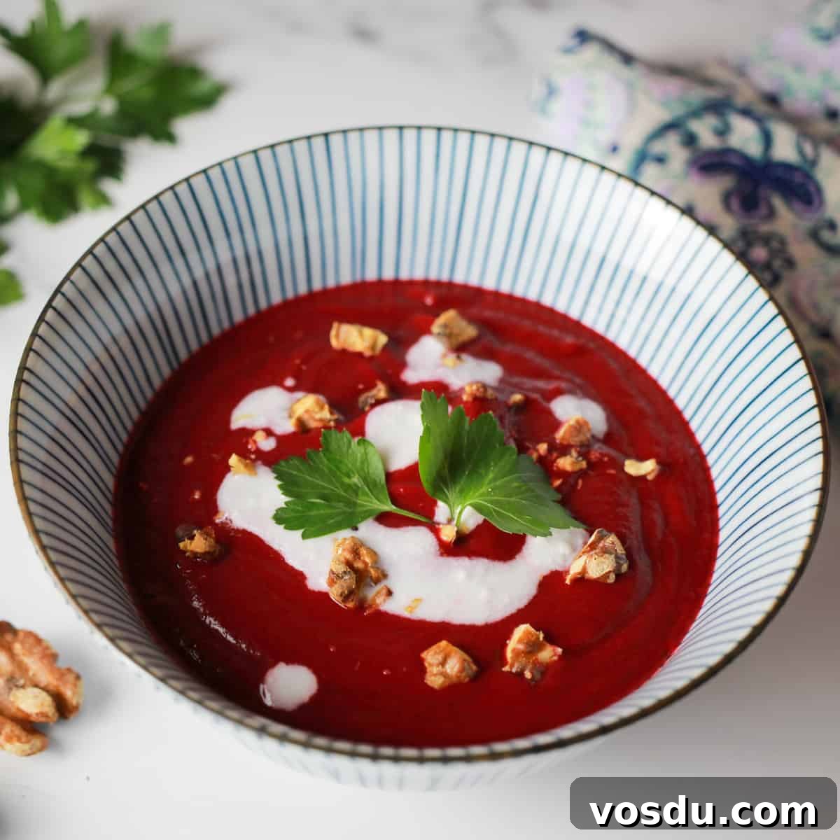 photo of a blue and white striped bowl with deep pink beetroot and walnut soup
