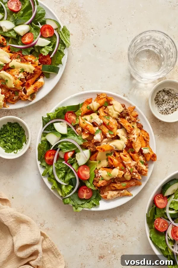 Dairy-Free Baked Ziti with Creamy Cashew Sauce 7 Several plates filled with Dairy Free Baked Pasta and side salads.