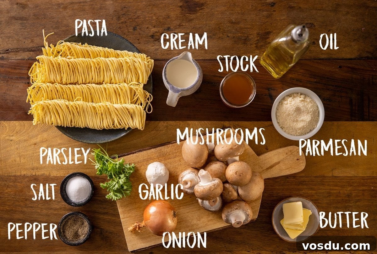 Creamy Mushroom Pasta Recipe with Garlic and Parmesan 3 All of the ingredients for creamy mushroom pasta laid out separately on a wooden table