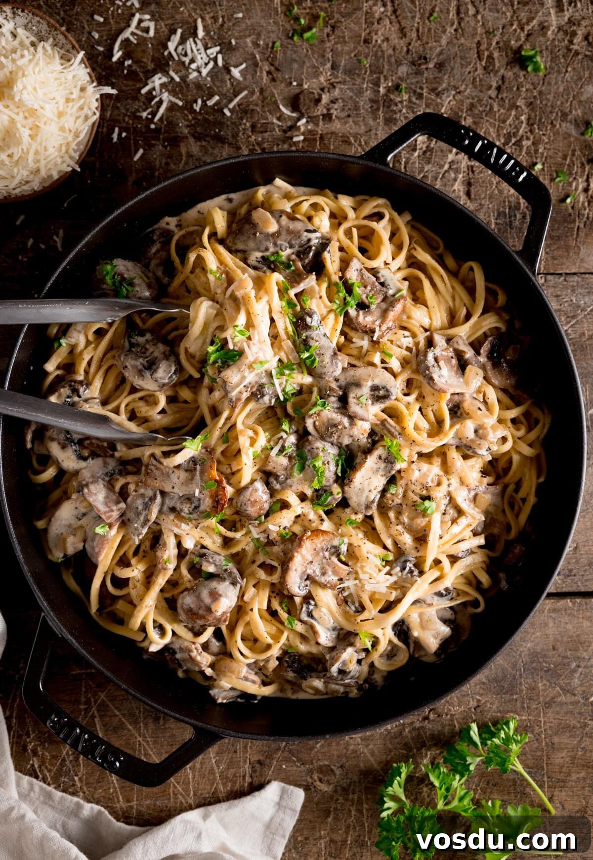 Creamy Mushroom Pasta Recipe with Garlic and Parmesan 4 A big pan of creamy mushroom pasta with a set of metal tongs stuck in