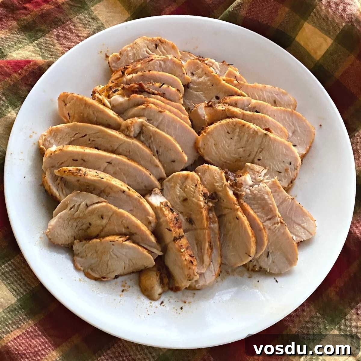 Juicy Oven-Baked Turkey Tenderloin with Herb Garlic Crust 4 Sliced turkey breast tenderloin on a plate.