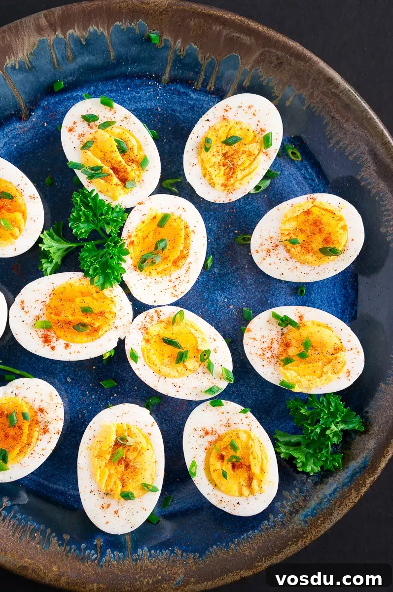 easy to peel hard boiled eggs cut in half on a blue platter