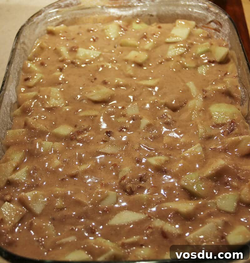 Decadent Caramel Apple Cake Recipe with Brown Sugar Glaze 5 Caramel Apple Cake ready to bake in dish.