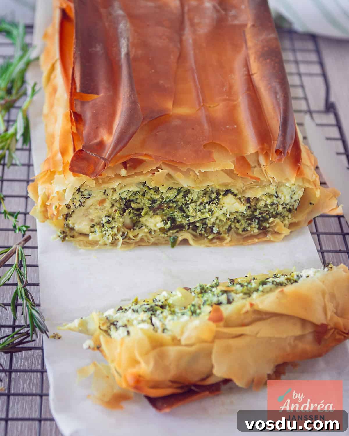 A quiche cut open to clearly see the spinach, feta and ricotta filling.