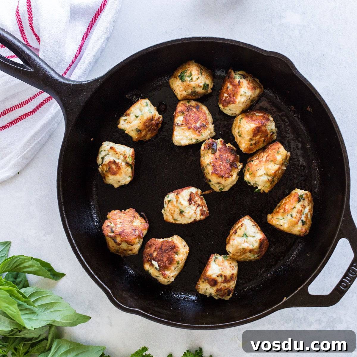 Cheesy Chicken Meatball Casserole with Tomato Basil Sauce 6 Skillet with browned chicken meatballs