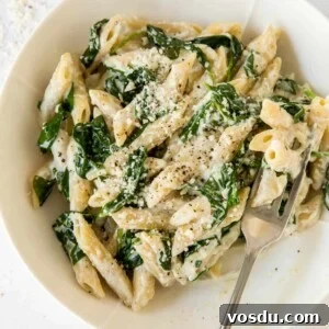 Creamy Spinach and Ricotta Pasta Recipe 6 spinach and ricotta pasta in a white bowl with a fork