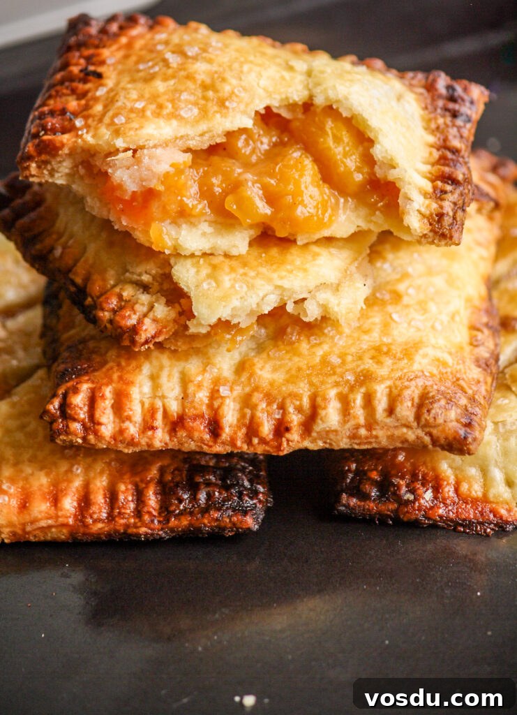 Buttery, flaky individual pies filled with jammy, cinnamon-scented peaches