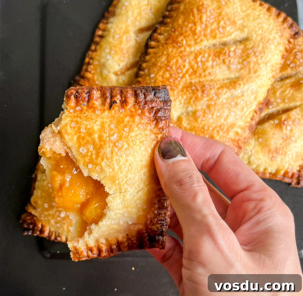 Buttery, flaky individual pies filled with jammy, cinnamon-scented peaches