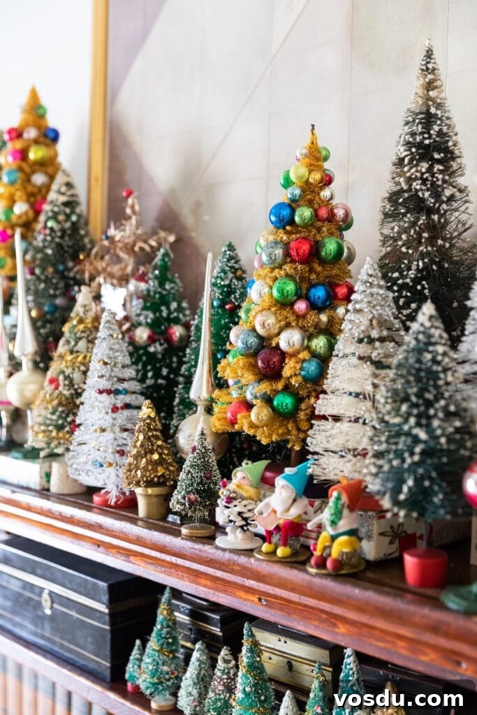 This Year’s Holiday Home Decor: Fresh Ideas to Transform Your Space 14 Bottle brush trees of all different shapes and sizes and colors sitting on dark colored wooden shelf