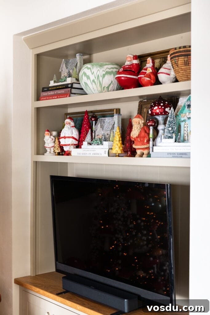 This Year’s Holiday Home Decor: Fresh Ideas to Transform Your Space 10 TV cabinet with shelves above adorned with Christmas Santas and glass Christmas trees