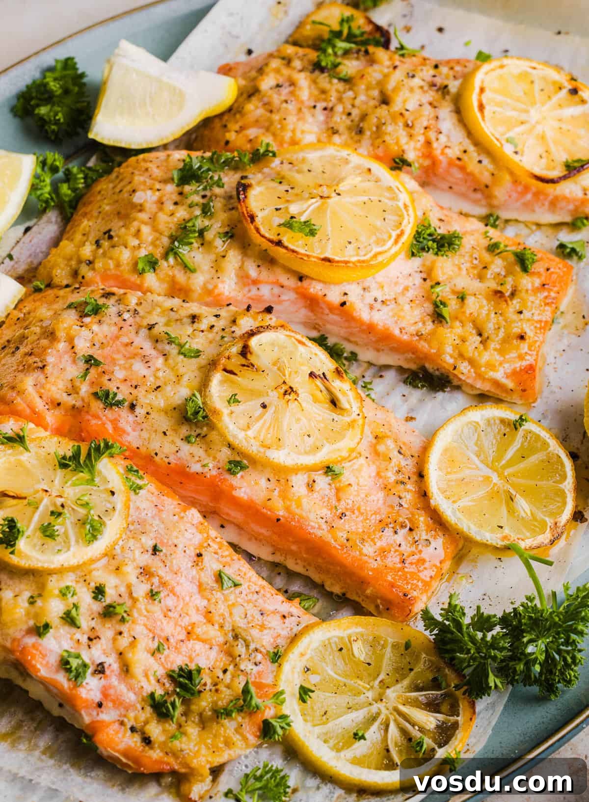 The most flavorful Garlic Butter Baked Salmon that is tender, flaky and coated in a rich garlicky sauce with lemon and Dijon. This simple healthy recipe easily comes together in under 20 minutes!