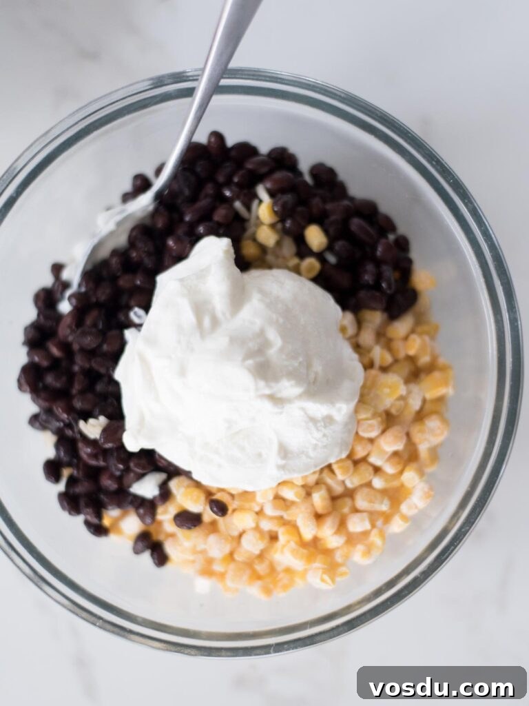 Sour cream added over the black beans.