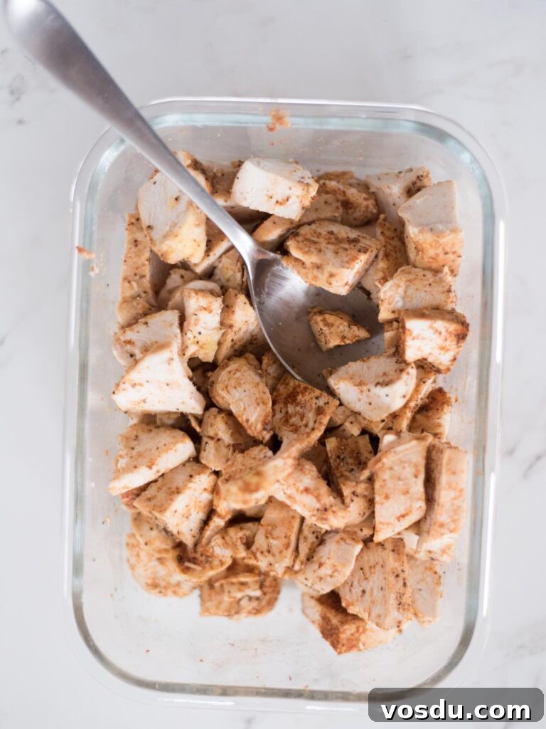 Diced chicken coated with taco seasoning combined.