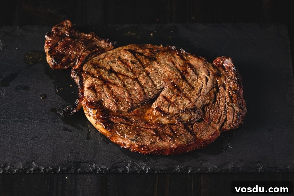 Charcoal grilled steak on a serving dish.