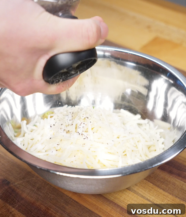 Korean Corn Cheese Recipe: Creamy Cheesy Corn Bake Tutorial 5 A creamy mixture of corn, mayo, cheese, and scallions being stirred together before baking Korean corn cheese.