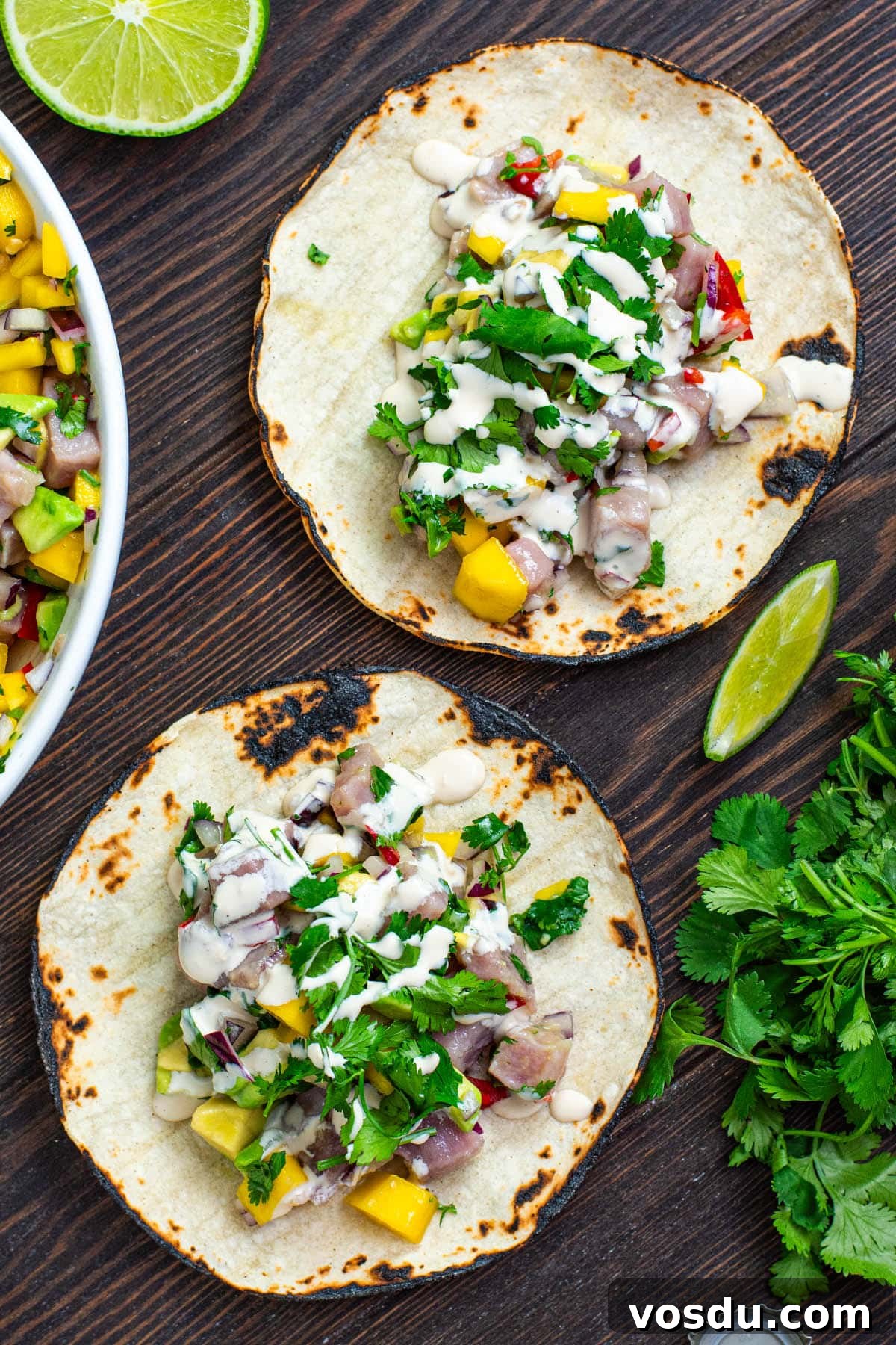 Tuna Ceviche Tacos with Lime, Avocado & Crispy Tortillas 2 Tuna ceviche with mango served on a corn tortilla with a drizzle of creamy mayo soy sauce.