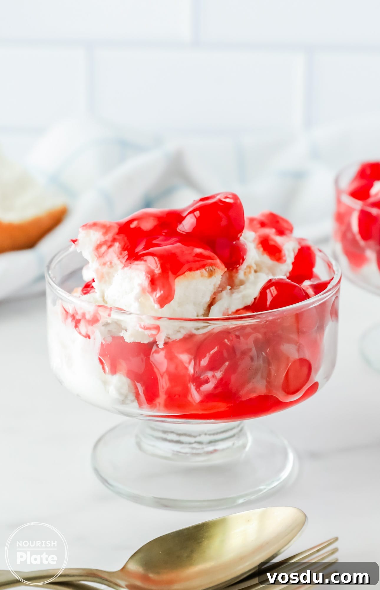 Cherries in the Snow served in a serving glass with a spoon on the side