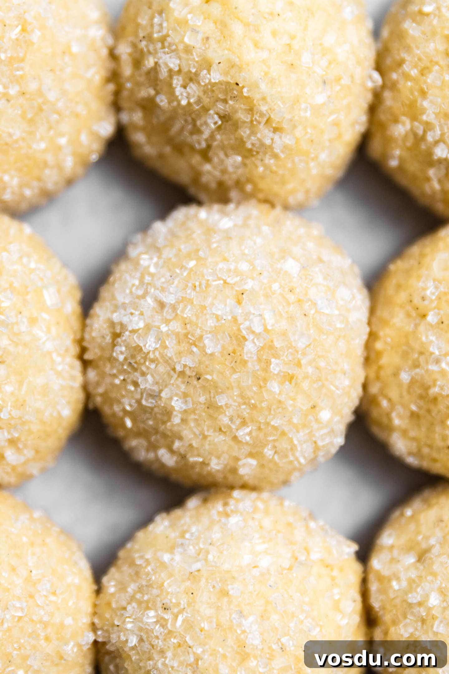 Simple Drop-Style Vanilla Sugar Cookies for Homemade Treats 8 Close up of sugar cookie dough balls rolled in sparkling sugar.