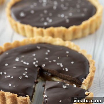 close-up of chocolate caramel tart with one slice cut