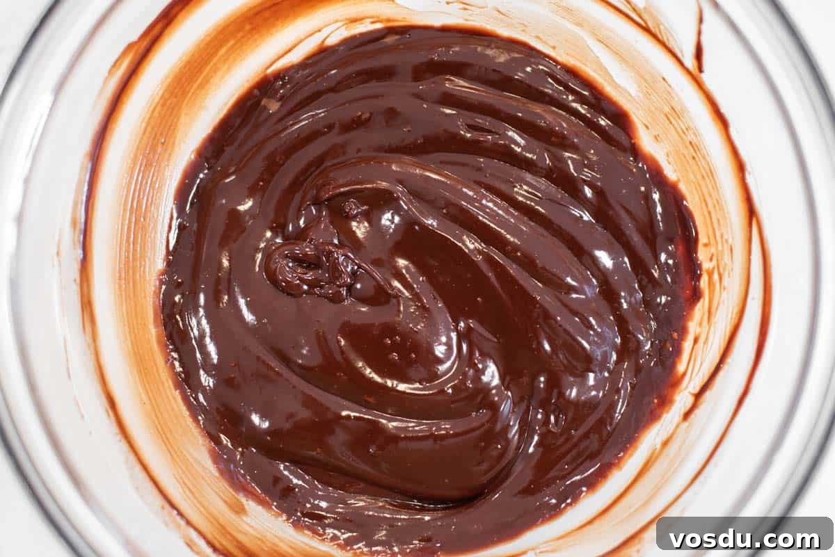 Decadent Oreo Cookie Tart Recipe 10 Chocolate ganache in glass bowl.