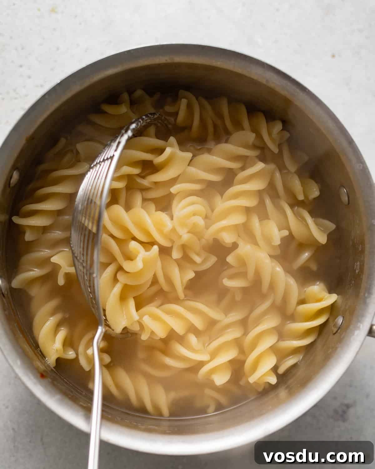 Shrimp Puttanesca Pasta Recipe with Tangy Tomato-Olive Sauce 4 boiled pasta in a saucepan.