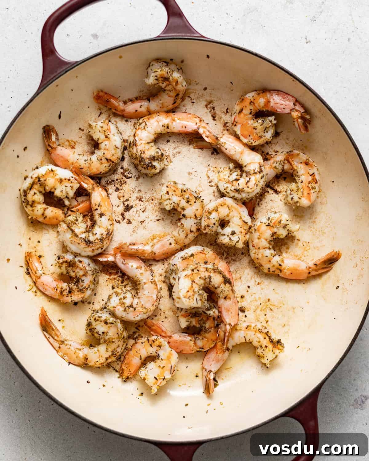 Shrimp Puttanesca Pasta Recipe with Tangy Tomato-Olive Sauce 6 cooked shrimp in a skillet.