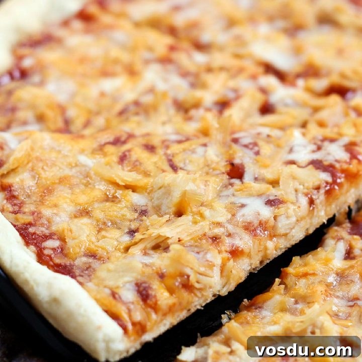 15 Quick Rotisserie Chicken Dinners for Busy Weeknights 14 Slice of pizza topped with chicken, cheddar cheese, and barbecue sauce being lifted from the pie.